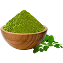 Moringa powder in wooden bowl with fresh moringa leaves, superfood ingredient