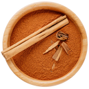 Bowl of Ceylon cinnamon powder with cinnamon sticks and bark pieces