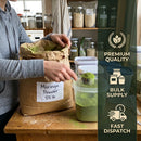 Person measuring moringa powder from a large bag into a container, with promotional text for premium quality, bulk supply, and fast dispatch on the right.