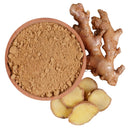 Bowl of ginger root powder with fresh ginger root and sliced ginger on white background