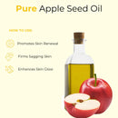 Apple seed oil in glass bottle with whole and sliced apples, benefits for skin listed