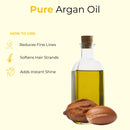 Glass bottle of pure argan oil with argan nuts and usage benefits text