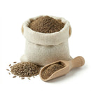Cumin seed powder in burlap sack with whole cumin seeds and wooden scoop on white background