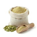 Ground green cardamom powder in a burlap sack with whole cardamom pods and a wooden scoop