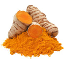 Whole turmeric roots and turmeric powder on a white background